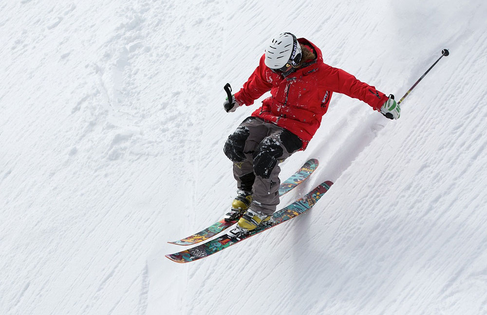 Skier at Sun Valley Resort in Idaho skiing down snowy mountain slope during winter