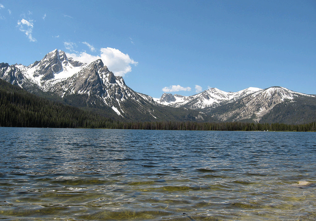 Stanley Lake in Idaho with clear water and snow-capped Sawtooth Mountains in the background