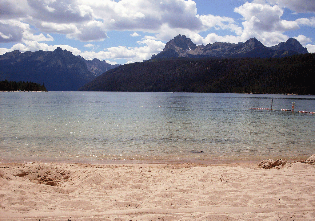 Redfish Lake in Idaho with sandy shoreline and Sawtooth Mountains in the background