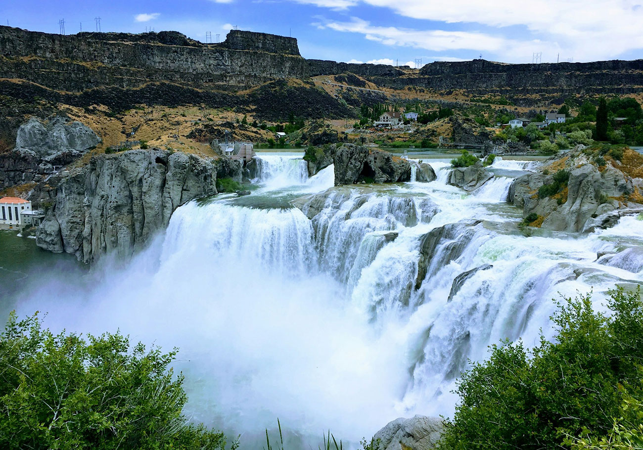 Shoshone Falls in Twin Falls Idaho with wide waterfall cascading over canyon cliffs