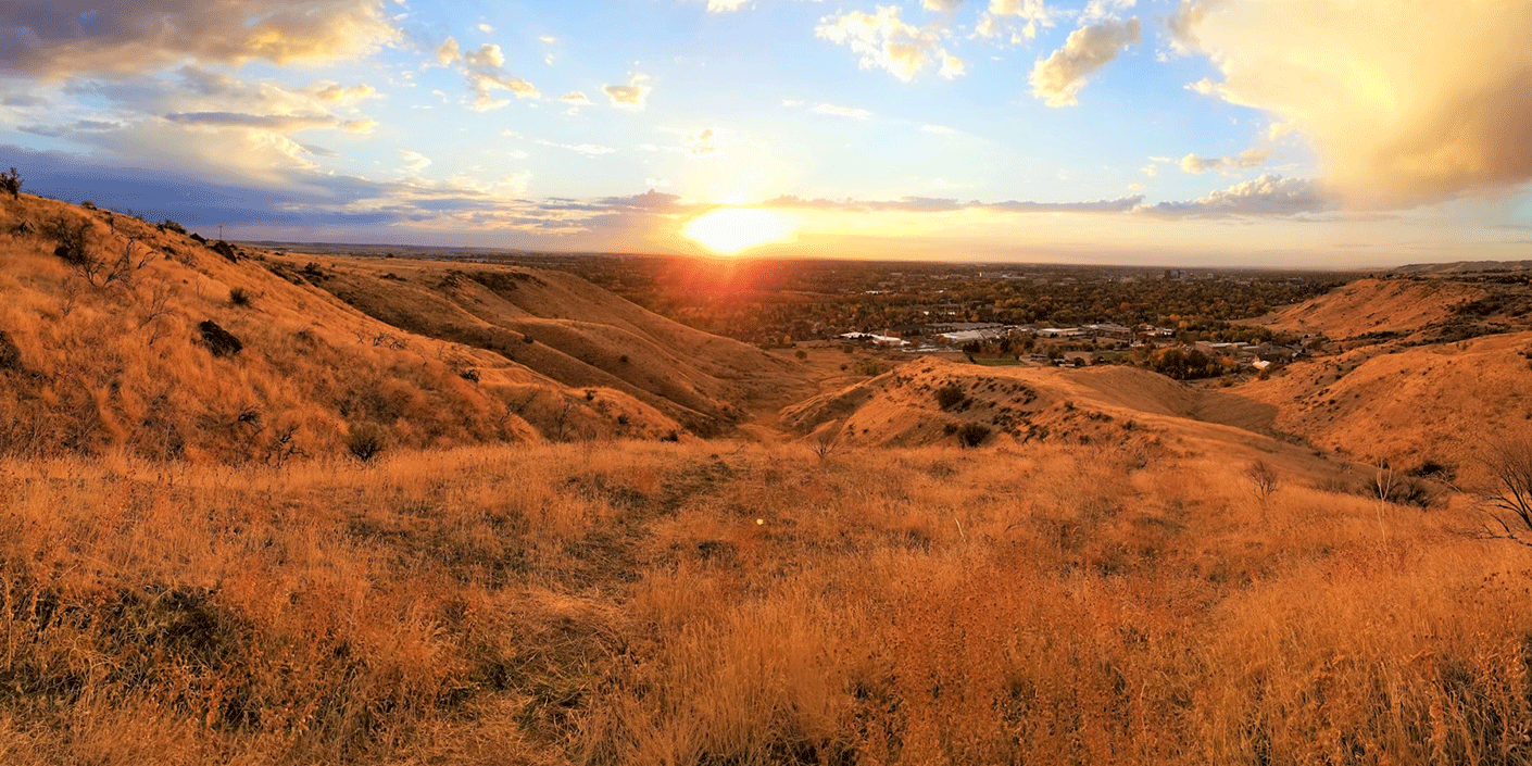 Boise Foothills in Idaho at sunset with rolling hills and golden grass landscape