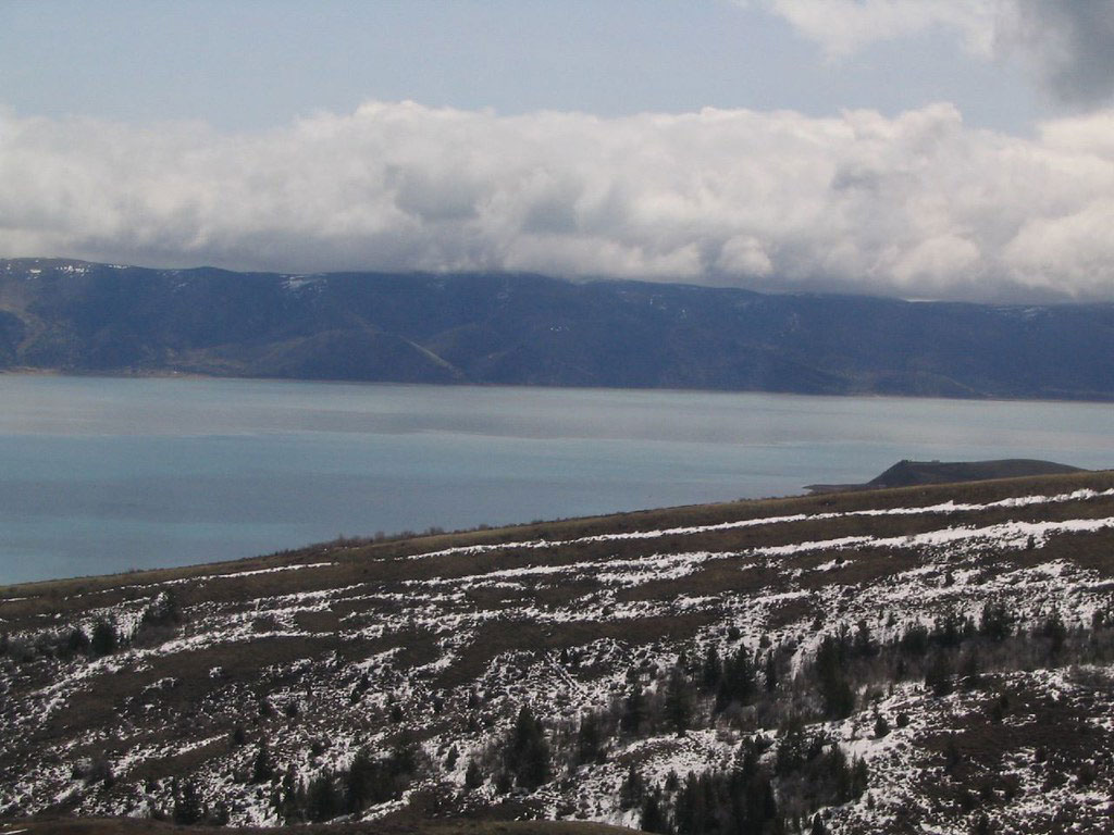 Bear Lake on the Idaho Utah border with blue water and surrounding mountain landscape