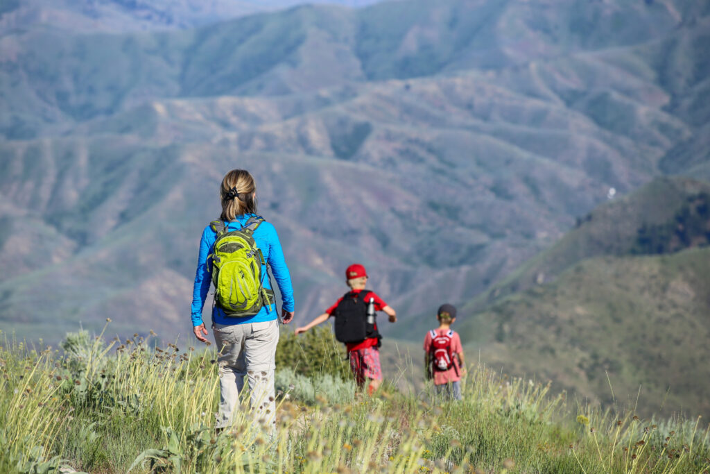 Visitors hiking a trail in the Boise foothills overlooking southern Idaho