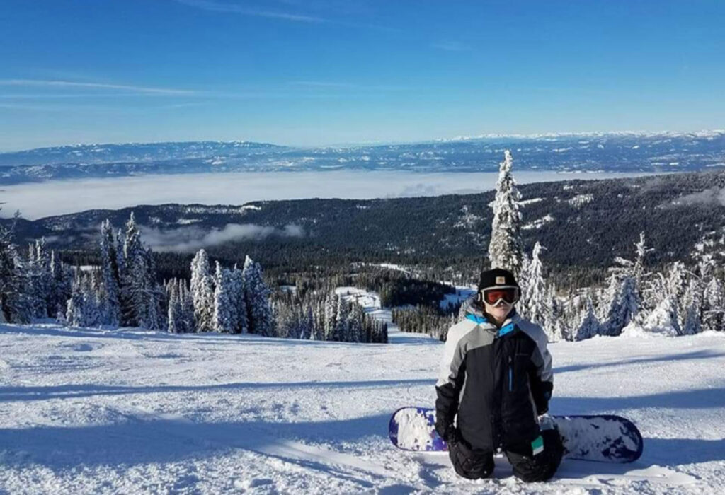 Young snowboarder enjoying winter views at Brundage Mountain in Idaho