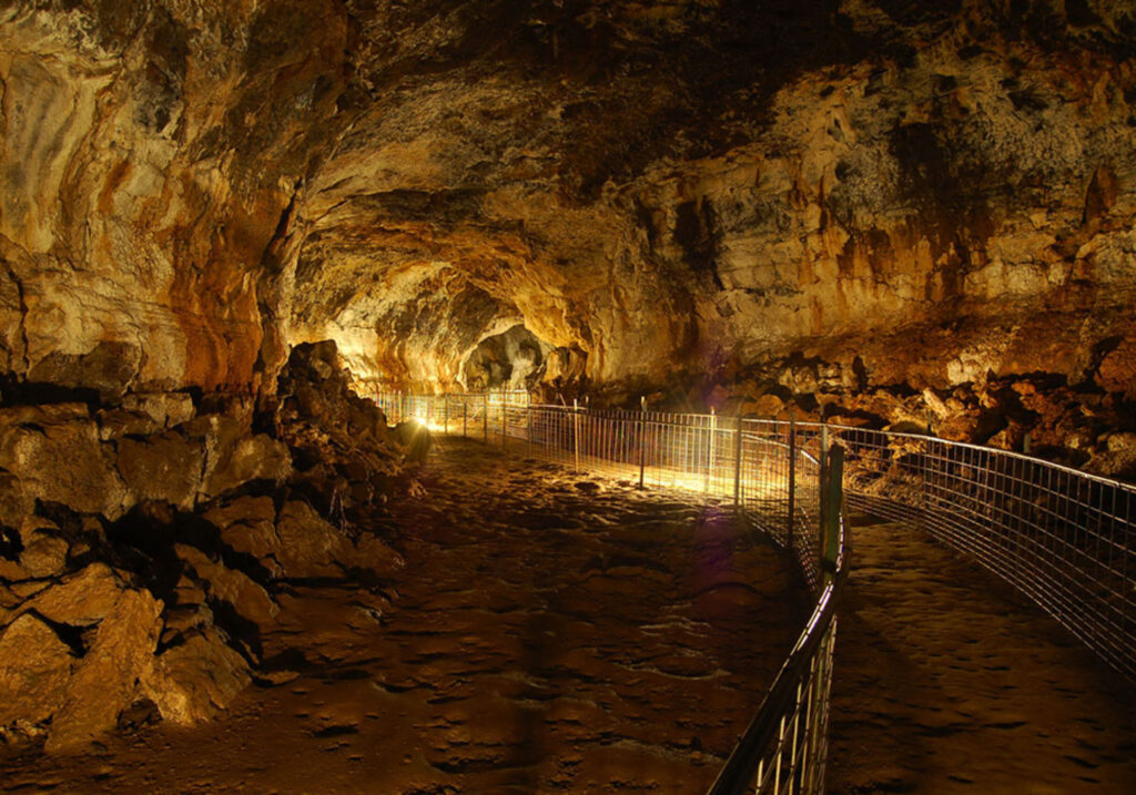 Interior of Idaho’s Mammoth Cave lava tube in Southern Idaho, a walk-through underground geological attraction formed by ancient volcanic flows.