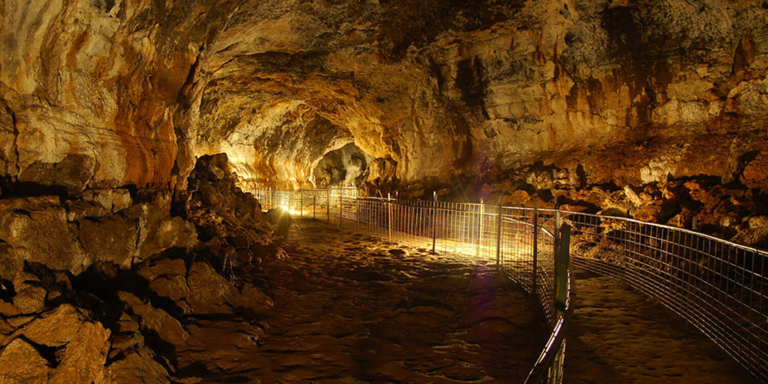 Interior of Idaho’s Mammoth Cave lava tube in Southern Idaho, a walk-through underground geological attraction formed by ancient volcanic flows.