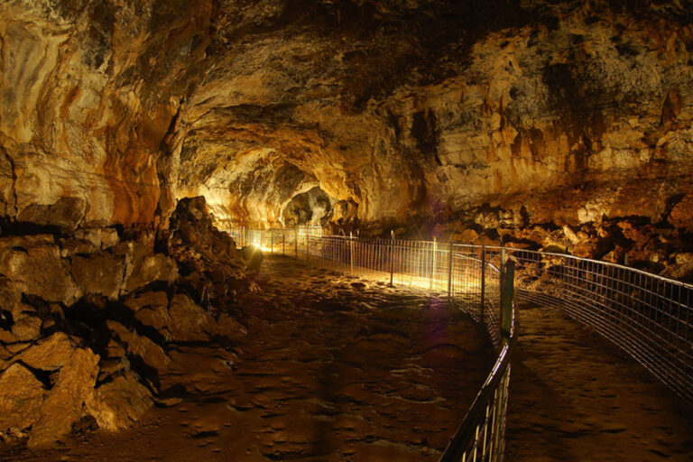 Interior of Idaho’s Mammoth Cave lava tube in Southern Idaho, a walk-through underground geological attraction formed by ancient volcanic flows.