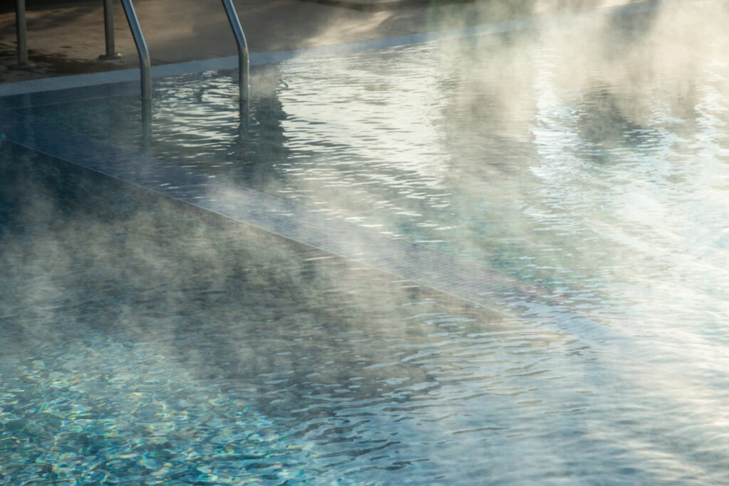 Steaming geothermal hot springs pool in Southern Idaho, a relaxing stop for travelers on a Southern Idaho road trip.