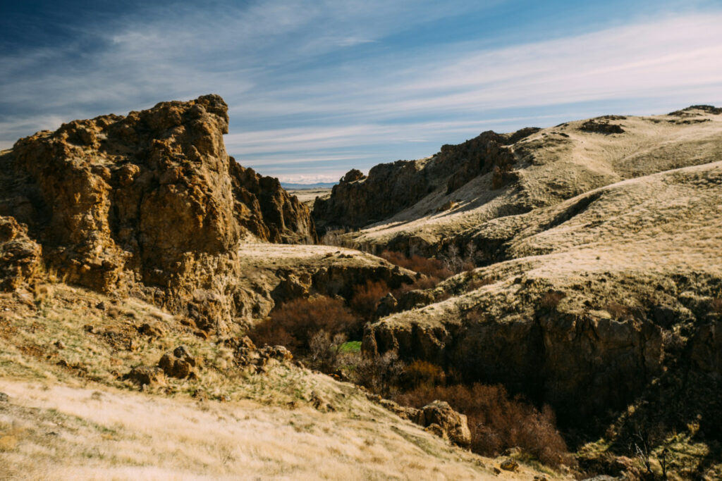 Idaho canyon landscape with rocky cliffs, rolling hills, and varied terrain