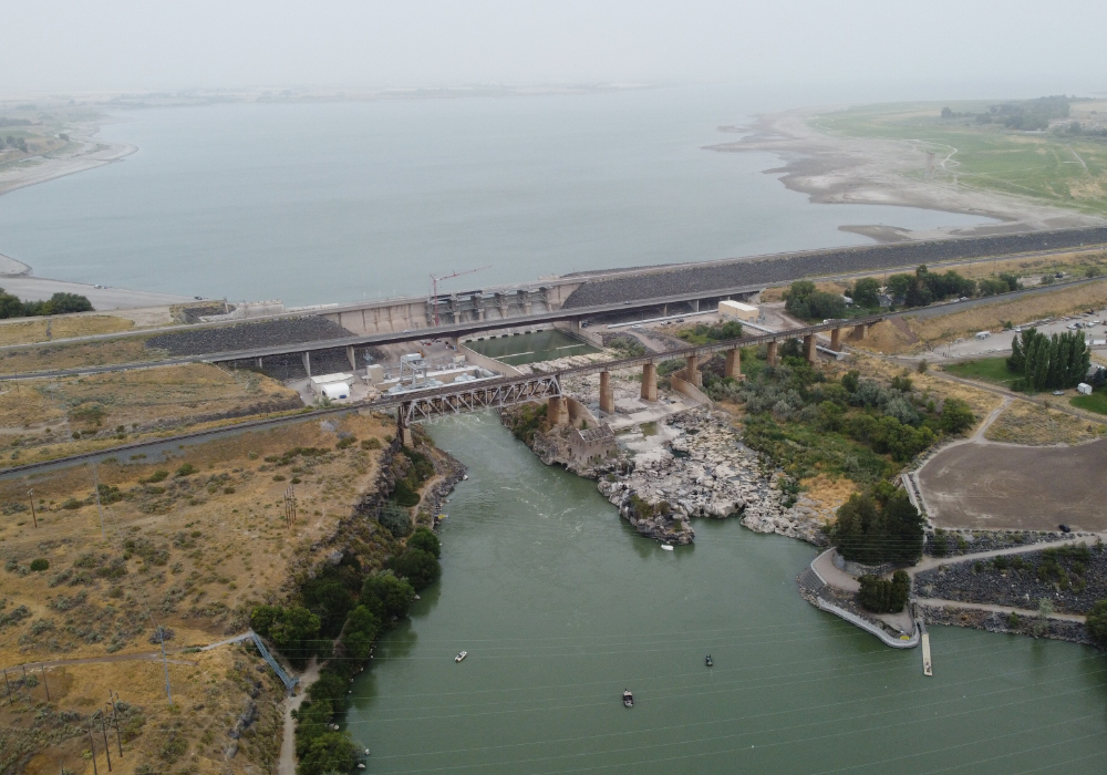 American Falls Dam in Idaho with Snake River, reservoir, and bridge structures from aerial view