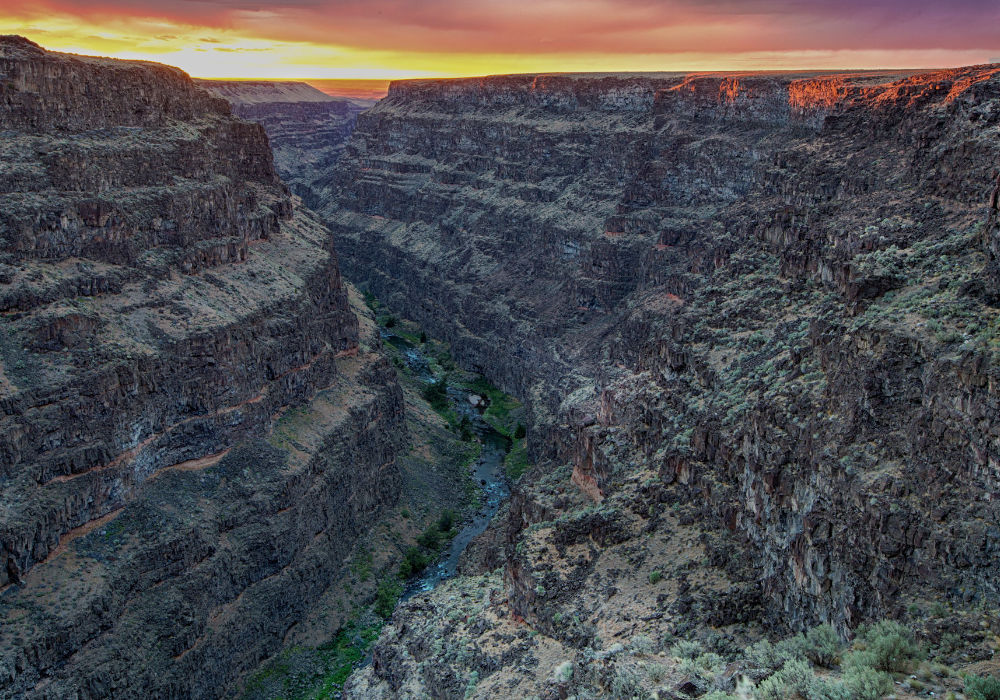 Bruneau River Canyon in southwestern Idaho at sunset with steep canyon walls and river below