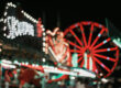 Carnival rides lit up at night at the Magic Valley Fair and Rodeo in Idaho, showing the lively fair atmosphere visitors can expect