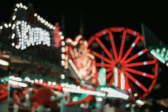 Carnival rides lit up at night at the Magic Valley Fair and Rodeo in Idaho, showing the lively fair atmosphere visitors can expect
