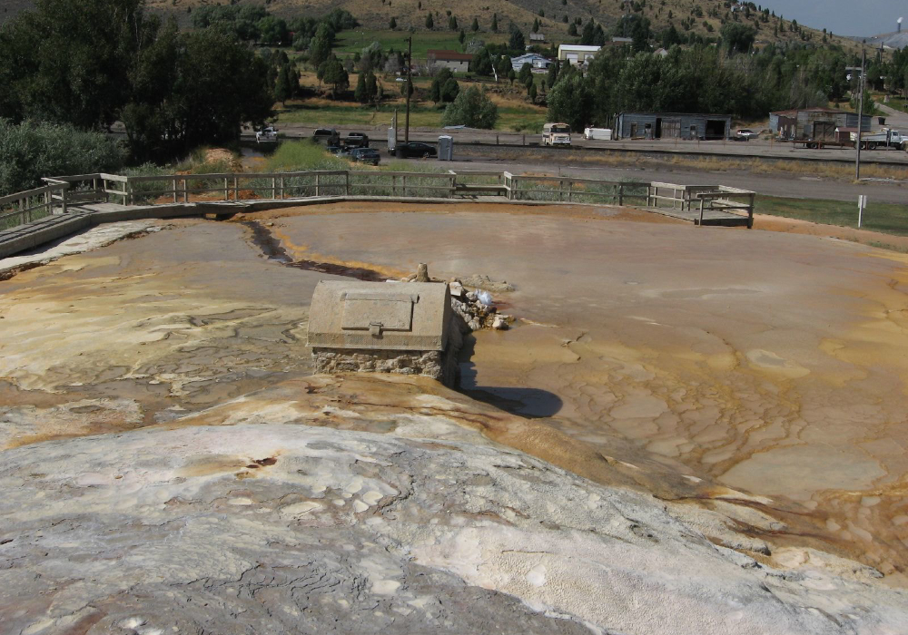 Ground view of Soda Springs Geyser in Idaho showing mineral deposits and viewing area, a unique stop for things to do in Idaho