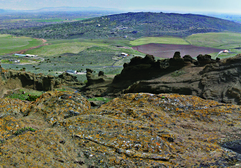 menan-buttes-volcanic-craters-idaho View from the top of the Menan Buttes volcanic craters overlooking lava rock formations and farmland near Rexburg, Idaho