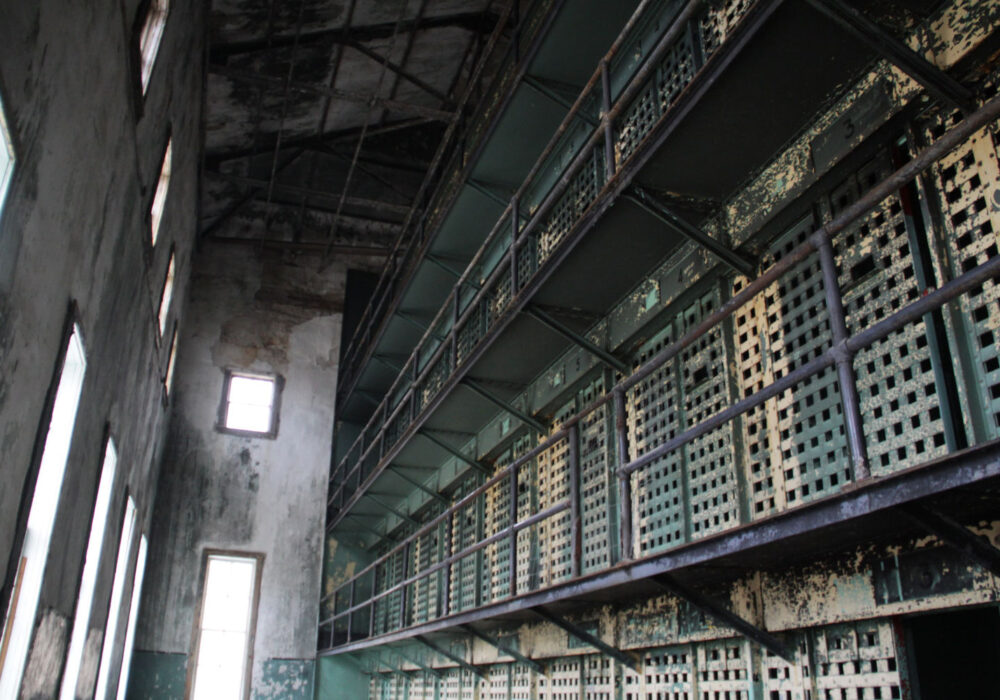 old-idaho-state-penitentiary Interior of the Old Idaho State Penitentiary featuring rusted prison cell blocks and multi-level walkways in Boise, Idaho