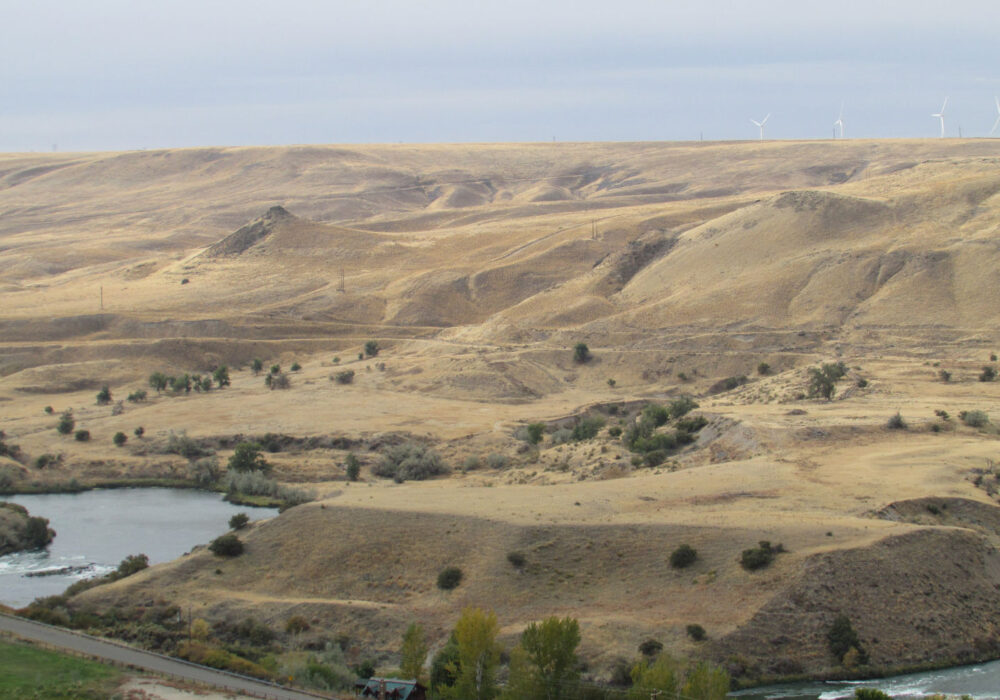 hagerman-fossil-beds-national-monument-idaho Rolling hills and river canyons at Hagerman Fossil Beds National Monument in Idaho, showcasing the rugged landscape where thousands of Ice Age fossils have been discovered.