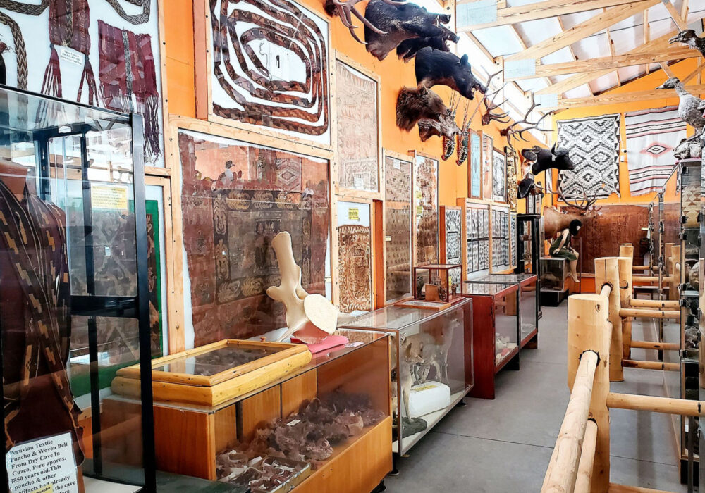 richard-arthur-olsen-museum-natural-history-idahos-mammoth-cave Interior of the Richard Arthur Olsen Museum of Natural History at Idaho's Mammoth Cave showing Peruvian textiles, mounted elk and bear, ancient artifacts, and cultural collections from around the world