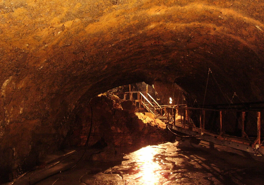 shoshone-ice-cave-closed-2026-lava-tube-shoshone-idaho Interior of the Shoshone Ice Cave lava tube near Shoshone Idaho showing frozen ice floor and walkway structure currently closed for repairs in 2026